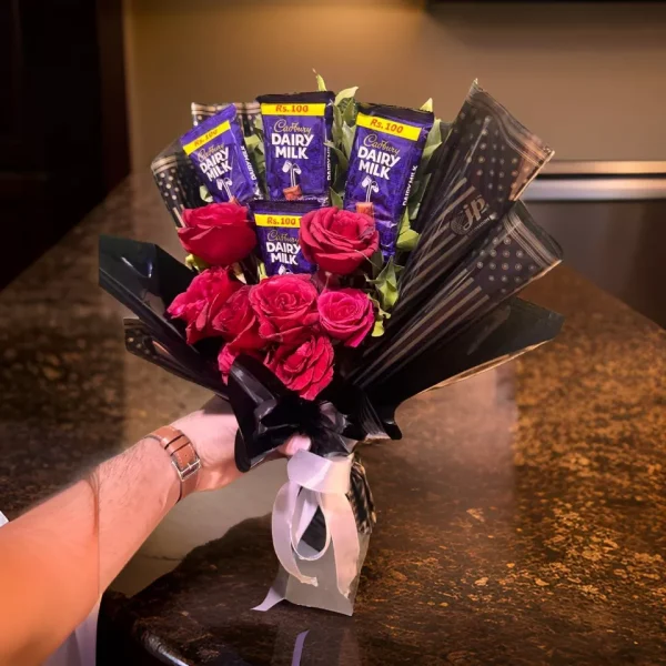 Bouquet of English Red Roses surrounded by Dairy Milk Chocolates