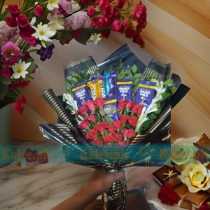 A delightful Chocolates Bouquet with Roses, featuring premium chocolates paired with fresh roses and fragrant tuberose flowers for a perfect gift.