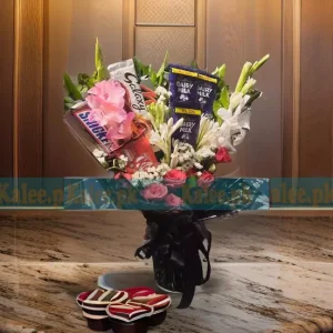 A delightful Flowers Chocolates Bouquet, featuring Galaxy, KitKat, Snickers, and Dairy Milk chocolates, elegantly arranged with glades, red roses, and statice flowers.