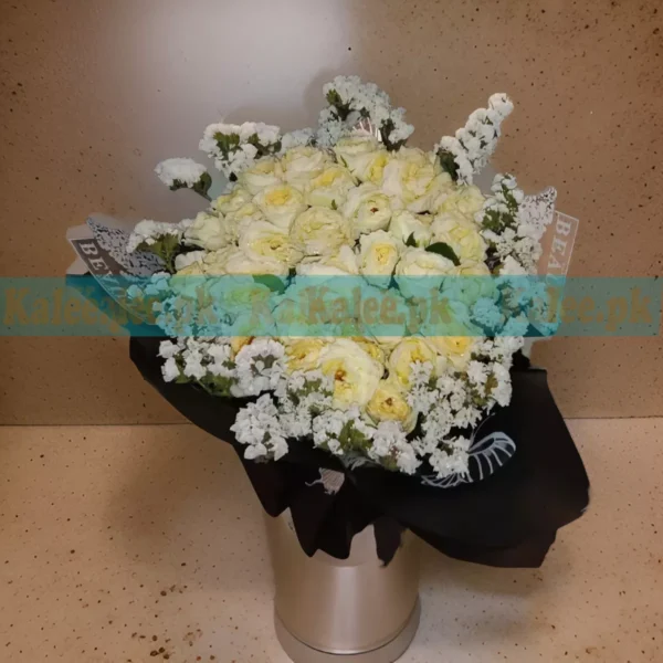 A bouquet featuring bright yellow English roses and delicate statice flowers