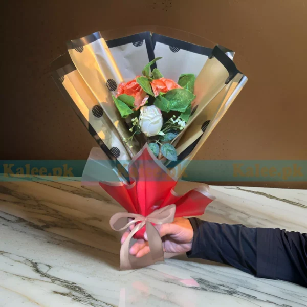 A meticulously crafted bouquet featuring orange and white flowers, exuding elegance and sophistication
