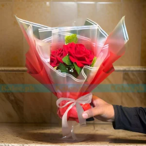 A stunning artificial bouquet featuring vibrant red roses, radiating eternal beauty