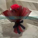 A glamorous crochet bouquet featuring stylish handmade red roses