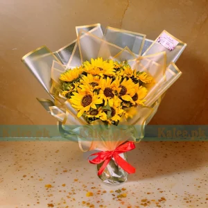 Sunflower bouquet with foliage accents glowing in golden hues.