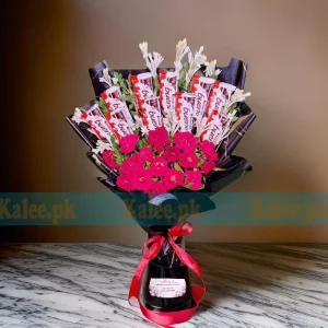 A bouquet of Kinder chocolates with red roses.