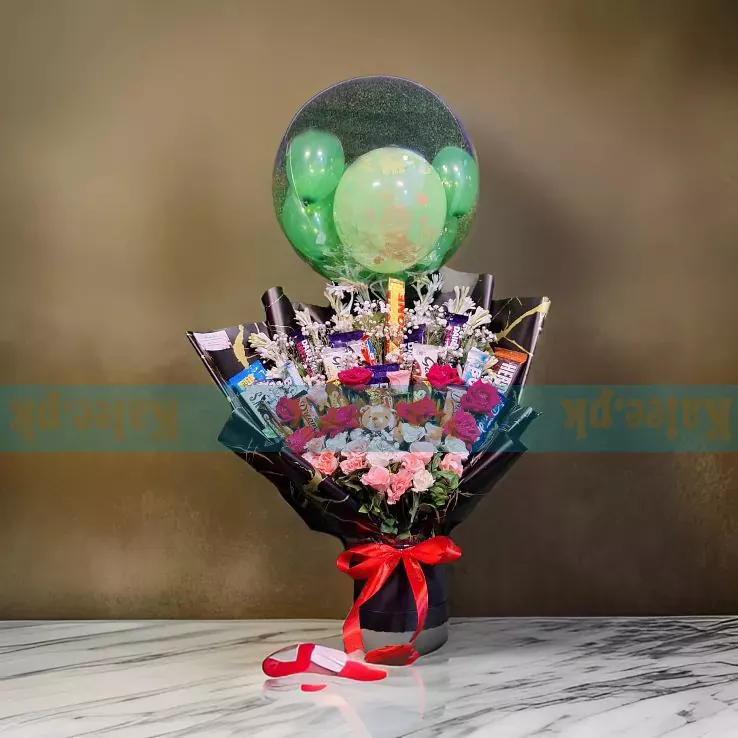 A box with chocolates, a balloon, and mixed flowers.