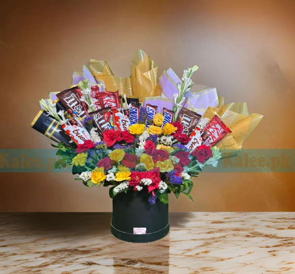 A box containing chocolates and colorful mixed flowers.