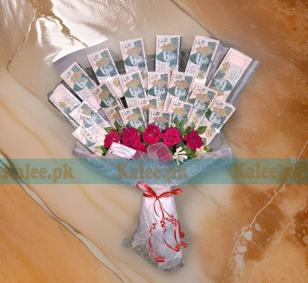 A bouquet featuring money arranged with English roses.