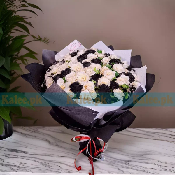 A bouquet of white and black roses.