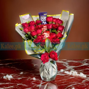 A bouquet with chocolates and English red roses.