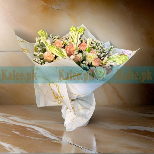 A bouquet of pink roses, tuberose, and statice flowers.