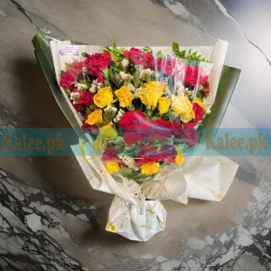 A bouquet of red and yellow roses with statice flowers.