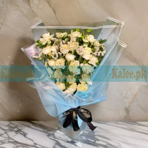 A Creamy White Roses Bouquet with statice flowers.