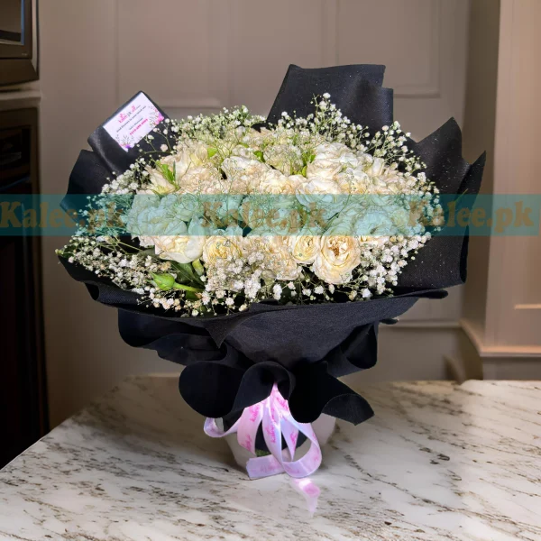 A bouquet of creamy white roses with baby's breath.