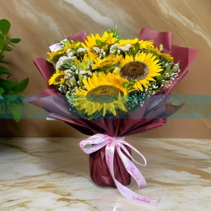 A bouquet featuring imported sunflowers, baby's breath, and statice flowers.