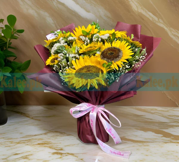 A bouquet featuring imported sunflowers, baby's breath, and statice flowers.