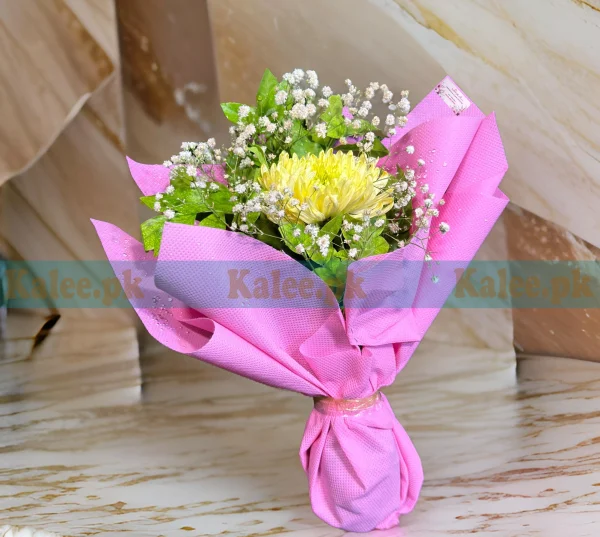 A bouquet featuring a single yellow daisy surrounded by baby's breath.