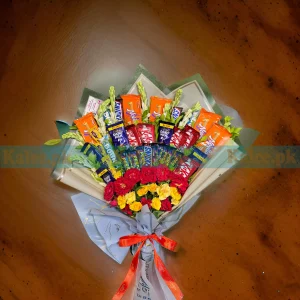 A fancy bouquet with chocolates and a variety of mixed flowers.