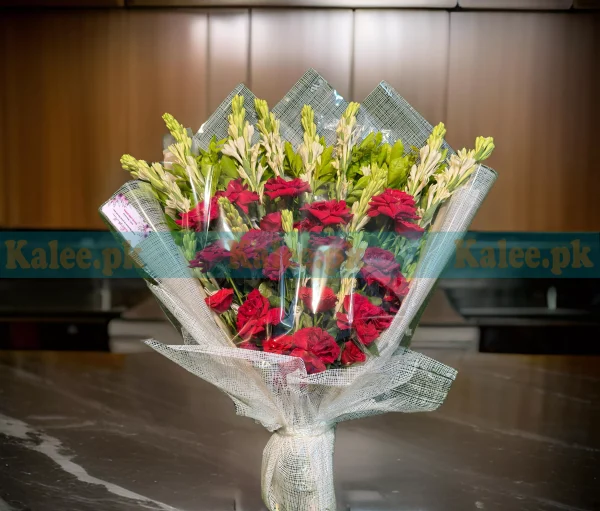 A bouquet of red roses and tuberose flowers.