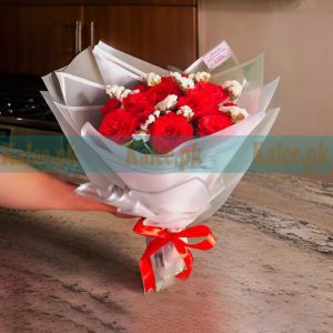 An elegant bouquet of English red roses paired with delicate white statice flowers.