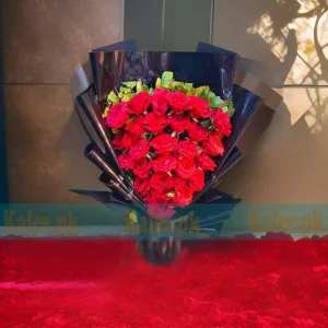 A striking bouquet of red roses elegantly wrapped in black paper for a bold and sophisticated look.