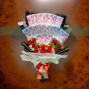 A creative bouquet featuring 50rs notes alongside vibrant red roses and delicate statice flowers, combining monetary and floral beauty.