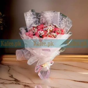 Bouquet with Statice, pink roses, and Baby’s Breath, elegantly wrapped with a satin ribbon.