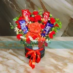 A Teddy Bear Flowers Box With Chocolates.