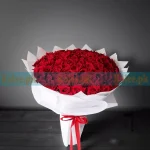 A stunning 100 English Red Roses bouquet, elegantly arranged for a luxurious and romantic floral gift.