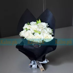 Fresh Rose Flowers bouquet with pure white roses, beautifully wrapped in decorative paper and finished with a satin ribbon.
