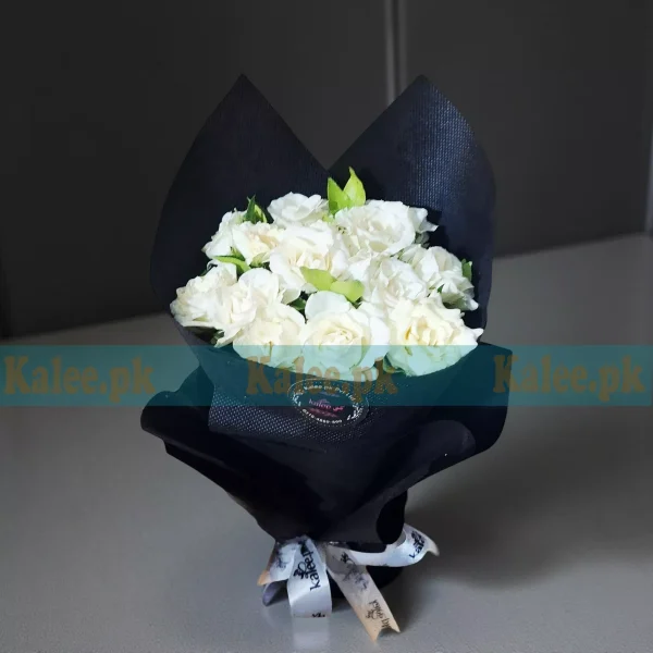 Fresh Rose Flowers bouquet with pure white roses, beautifully wrapped in decorative paper and finished with a satin ribbon.