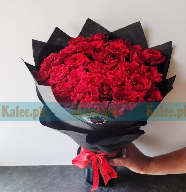 Red Rose Flowers Bouquet with fresh red roses, wrapped in decorative paper and finished with a satin ribbon.
